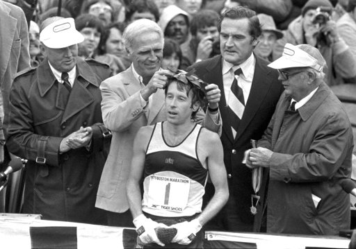 FILE - In this April 16, 1979 file photo, Bill Rodgers of Melrose, Mass., is crowned winner of the Boston Marathon by Mayor Kevin H. White, left, as Massachusetts Gov. Edward J. King, right, observes. A new film that captures much of the Boston Marathon's colorful history premieres Saturday, April 15, 2017, in conjunction with the 121st running of the race on Monday. (AP Photo, File)